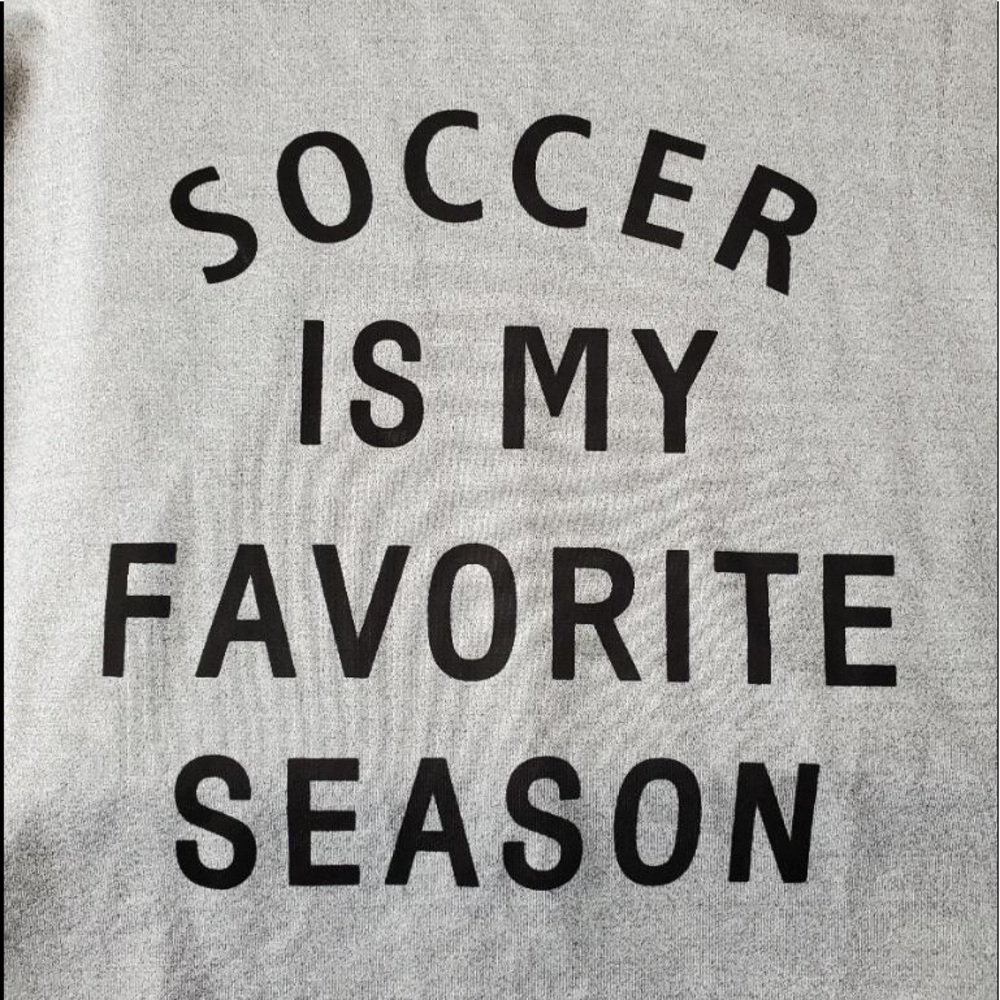 Long sleeve gray sweatshirt with heart on sleeve.